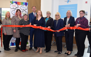 Group of people cutting ribbon