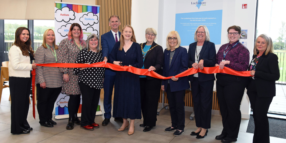 Group of people cutting ribbon