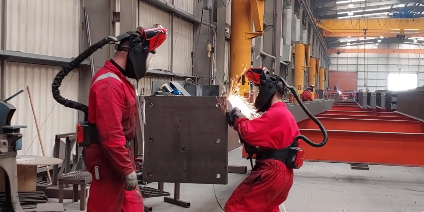 Two people welding