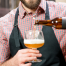 Person pouring drink from a bottle