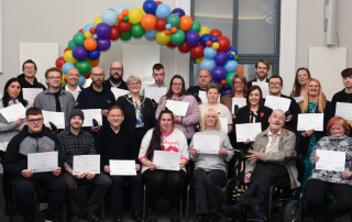 Group of people holding certificates