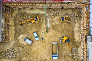 Overhead view of construction vehicles working on land