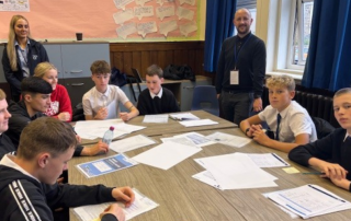 Group of school pupils around table